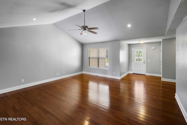 empty room featuring vaulted ceiling, ceiling fan, and dark hardwood / wood-style flooring