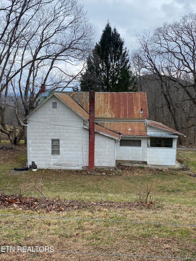 view of home's exterior with a lawn