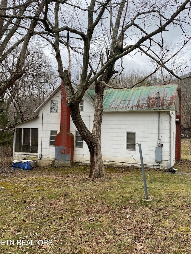 view of property exterior with a yard