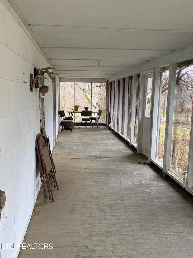 unfurnished sunroom with plenty of natural light