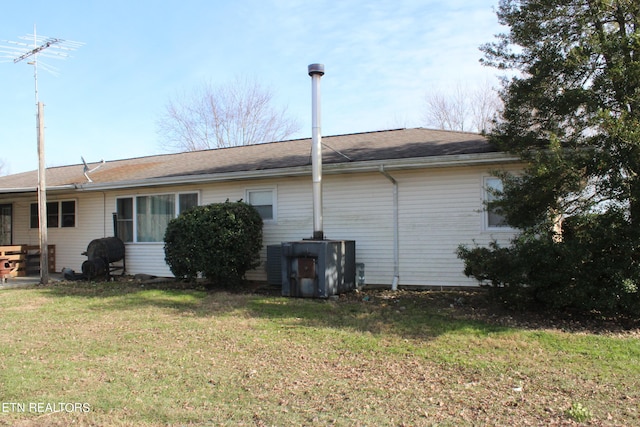 back of property featuring a yard