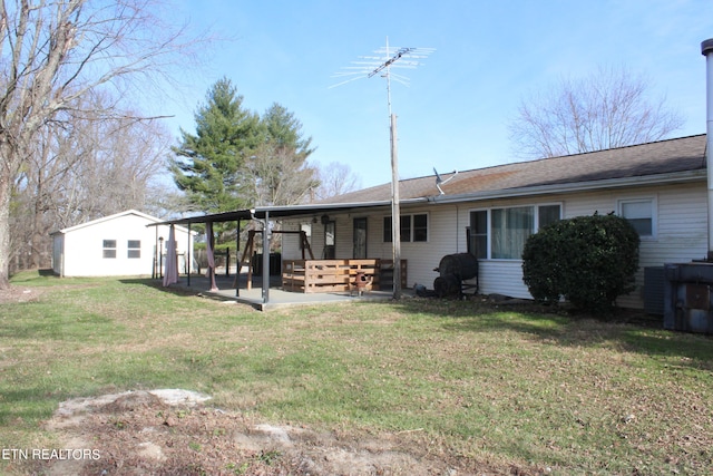 rear view of property featuring a patio and a yard