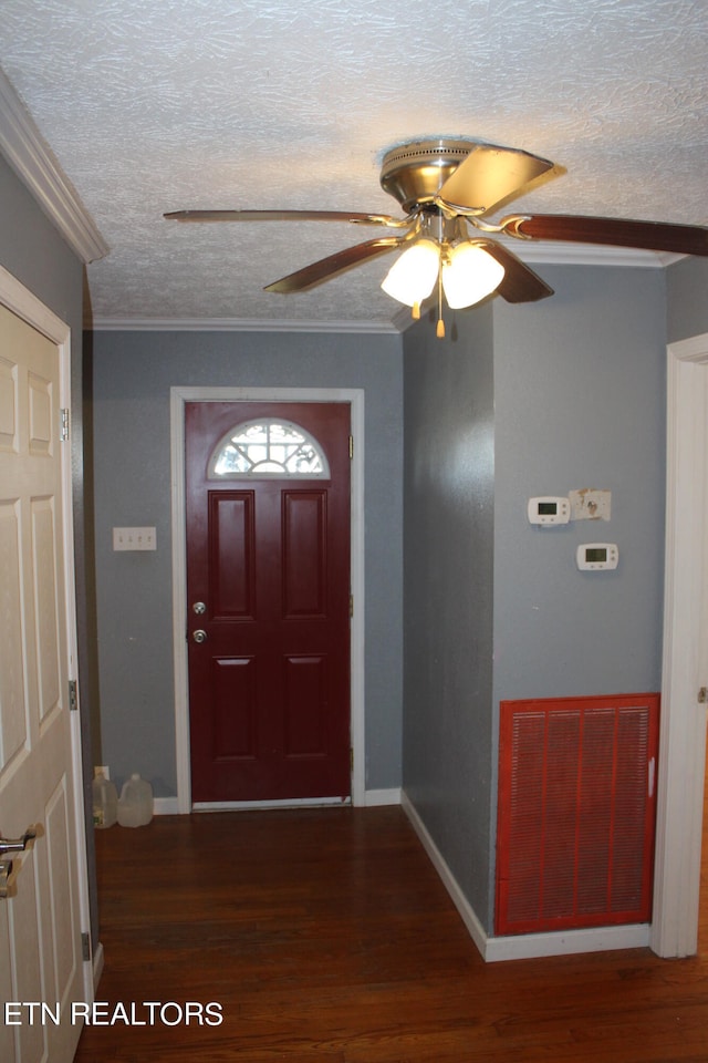 foyer with crown molding, dark hardwood / wood-style flooring, a textured ceiling, and ceiling fan