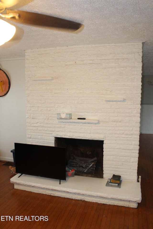 details with dark wood-type flooring and a textured ceiling