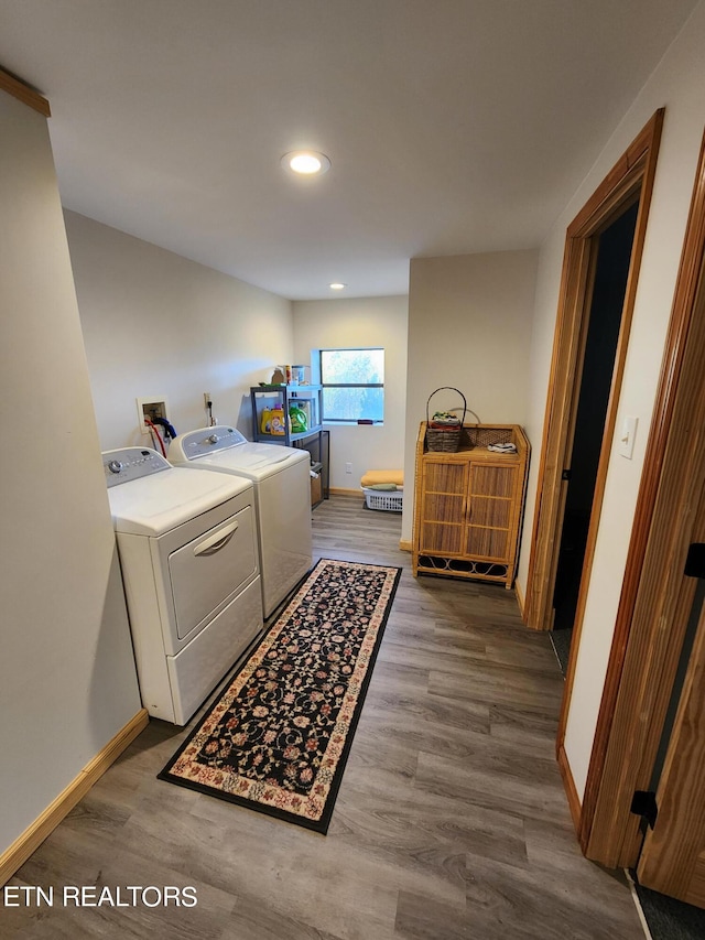 clothes washing area with washer hookup, washer and clothes dryer, and hardwood / wood-style flooring