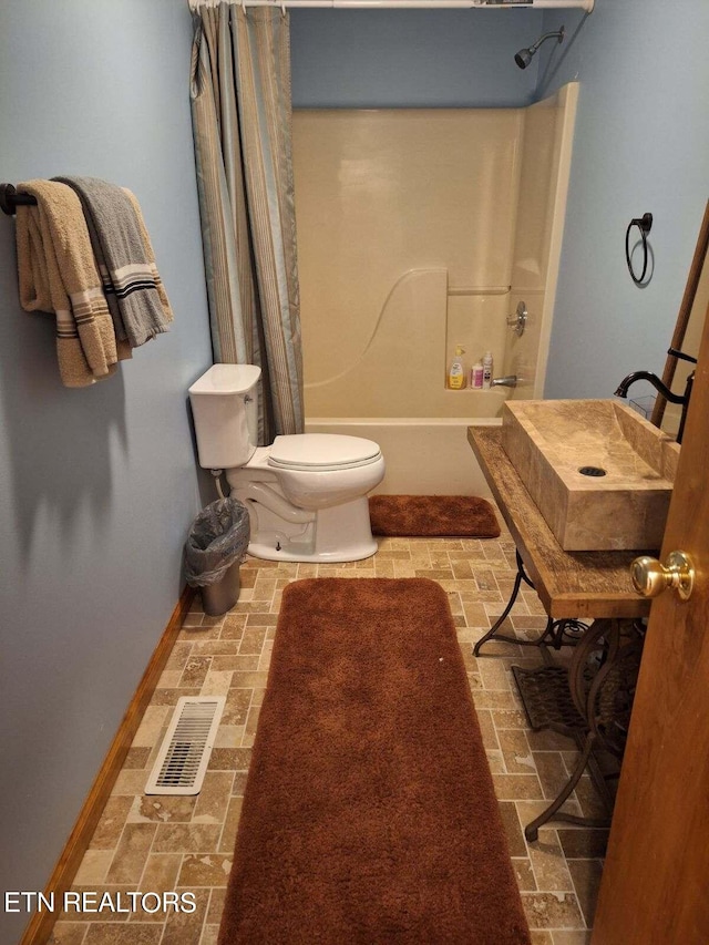 full bathroom with toilet, shower / tub combo, and sink