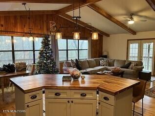 kitchen with light hardwood / wood-style floors, butcher block countertops, ceiling fan, and white cabinetry