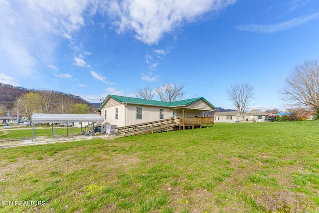 view of yard with a wooden deck and a carport