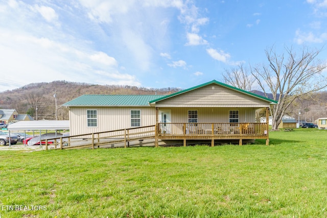 back of property featuring a yard and a wooden deck