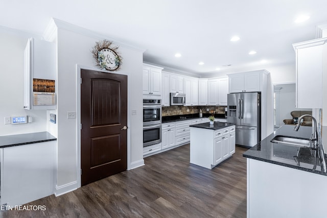 kitchen featuring white cabinets, dark wood-type flooring, sink, and stainless steel appliances