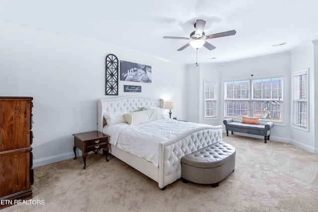 bedroom with crown molding, ceiling fan, and light colored carpet