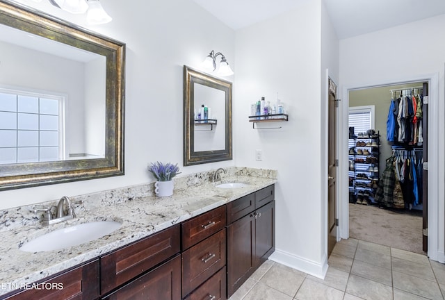 bathroom with dual bowl vanity and tile floors