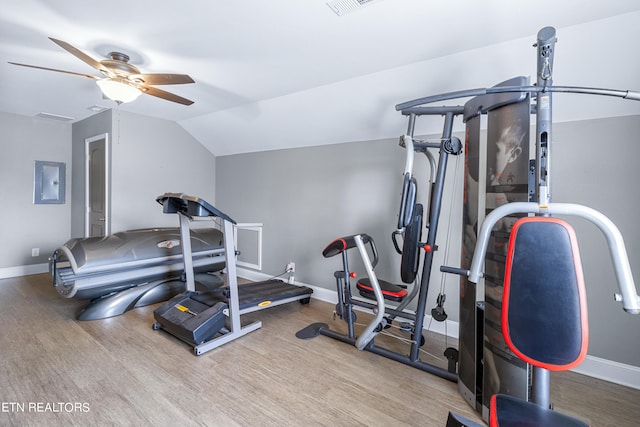 workout room with lofted ceiling, ceiling fan, and light wood-type flooring