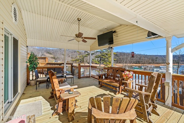 wooden terrace featuring ceiling fan