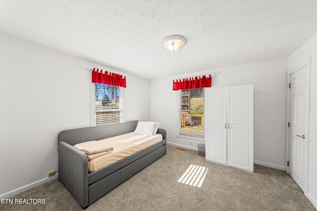 carpeted bedroom featuring a textured ceiling