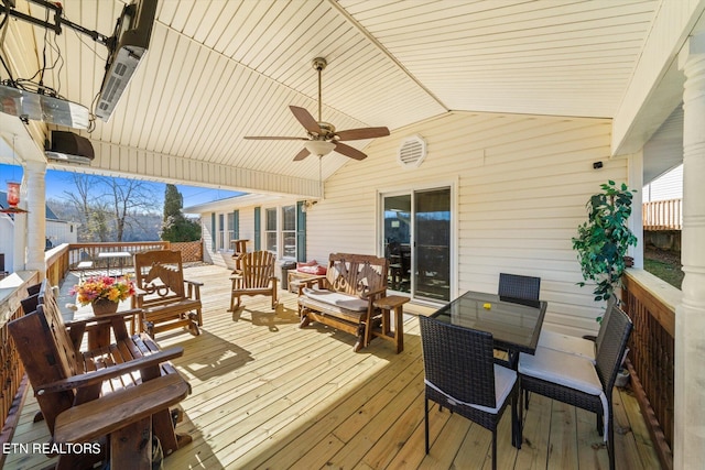 wooden terrace with outdoor lounge area and ceiling fan