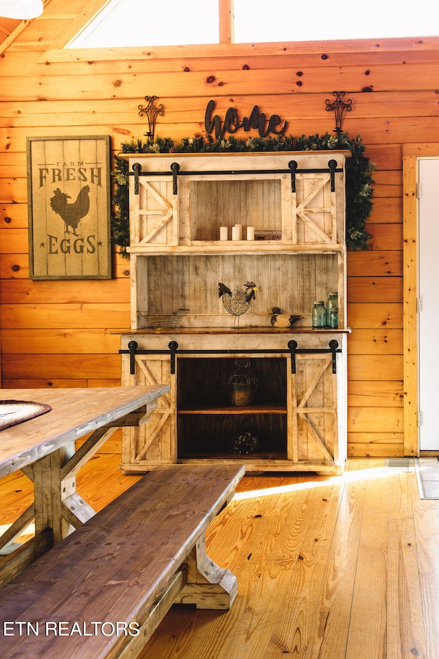 interior space featuring a barn door and wooden walls