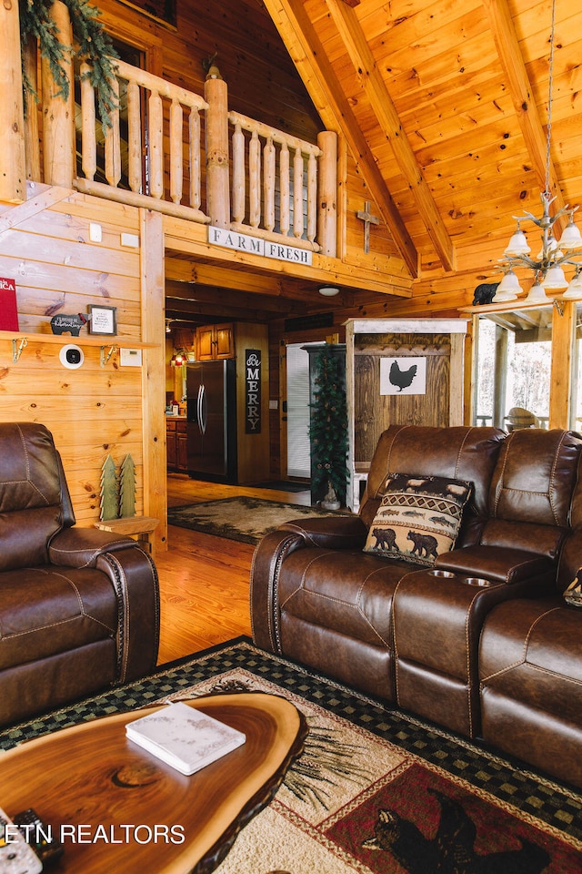 living room featuring wood walls, hardwood / wood-style flooring, a notable chandelier, wooden ceiling, and beam ceiling