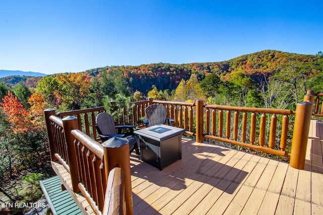 wooden terrace featuring an outdoor fire pit and a mountain view