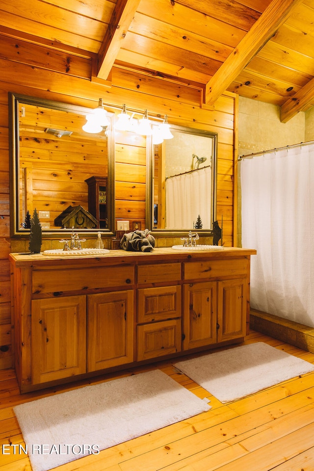 bathroom featuring wood ceiling, beam ceiling, and wood walls