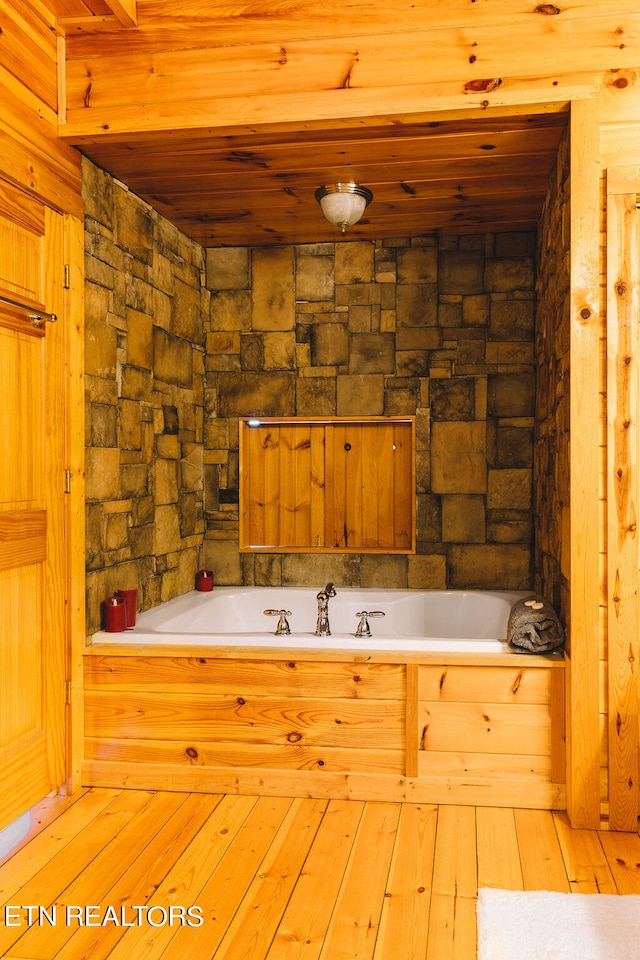 bathroom featuring wood ceiling and hardwood / wood-style floors