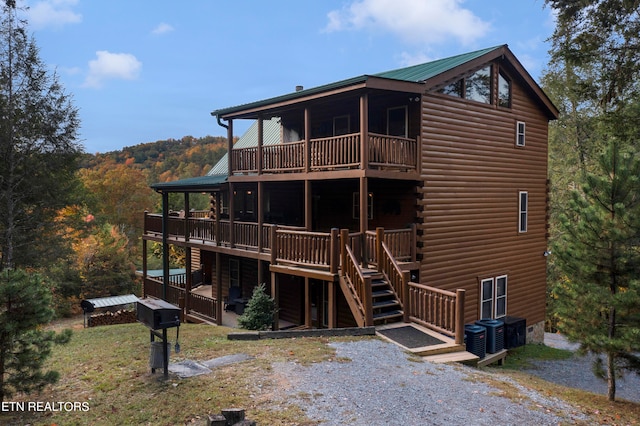 rear view of property featuring a deck