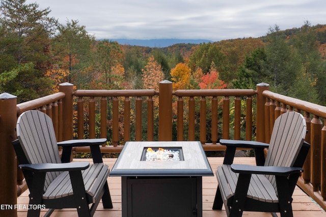 wooden deck featuring an outdoor fire pit