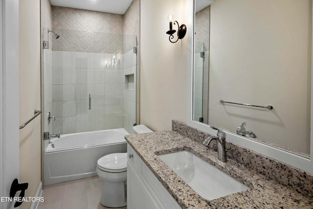 full bathroom featuring shower / bath combination with glass door, vanity, toilet, and tile floors