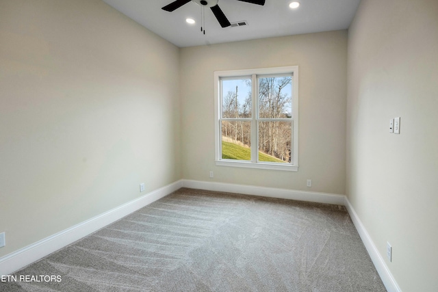 carpeted spare room featuring ceiling fan