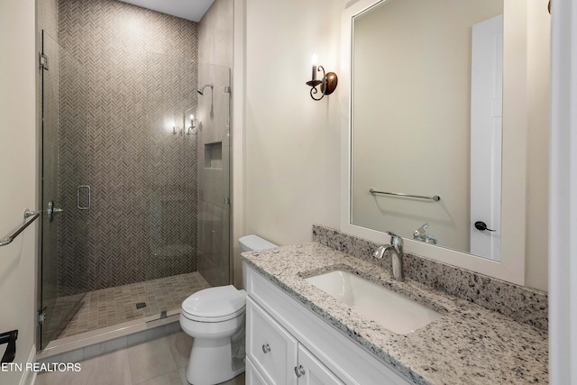 bathroom with walk in shower, tile flooring, oversized vanity, and toilet