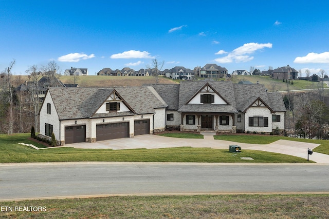 french country style house with a front lawn and a garage