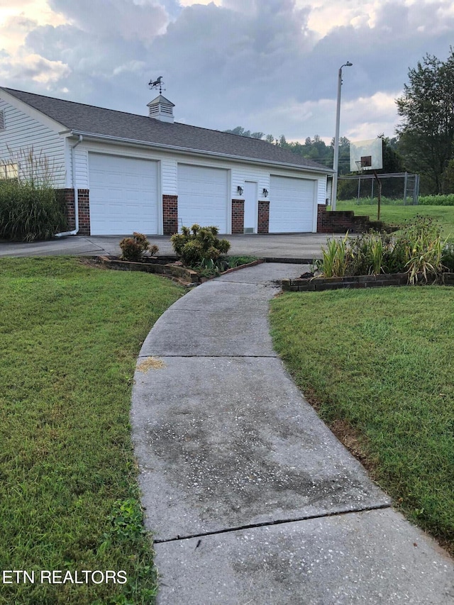 ranch-style house with a front lawn and a garage