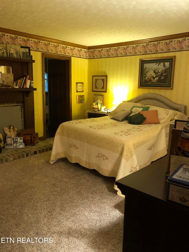 bedroom featuring a fireplace, ornamental molding, and carpet