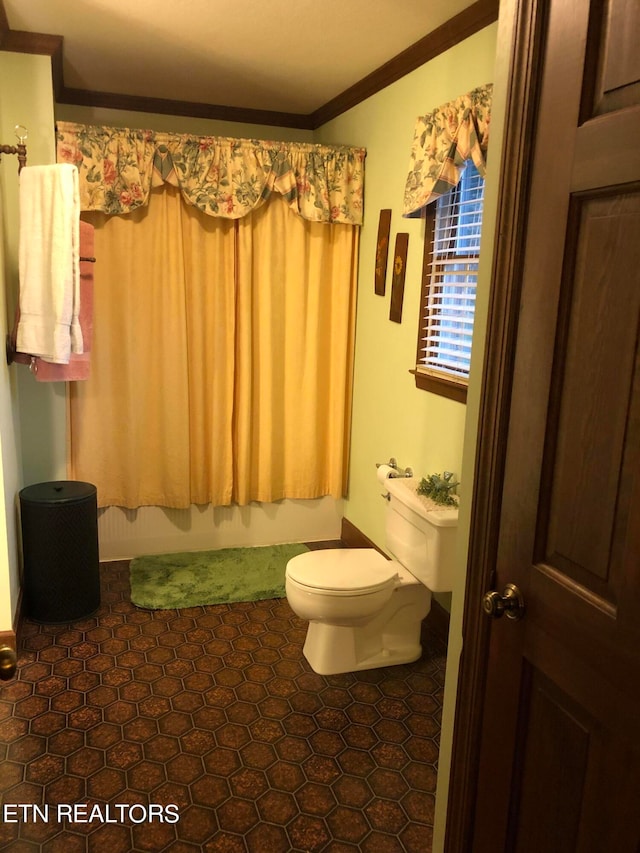 bathroom with ornamental molding, toilet, and tile floors