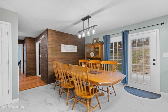 dining room with wooden walls