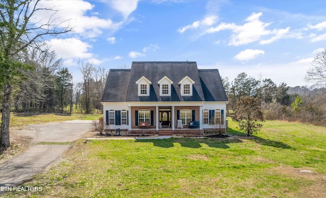 cape cod house with a porch and a front lawn