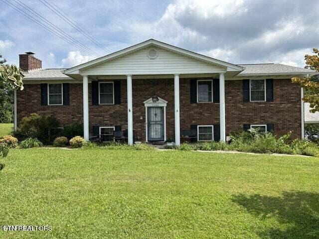 split foyer home with a front lawn