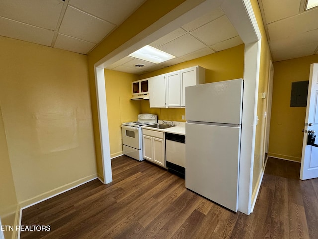 kitchen featuring white appliances, white cabinets, a drop ceiling, and dark wood-type flooring