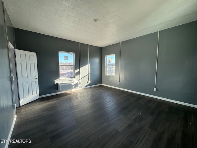 spare room with dark wood-type flooring