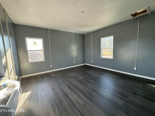 unfurnished room featuring dark hardwood / wood-style floors