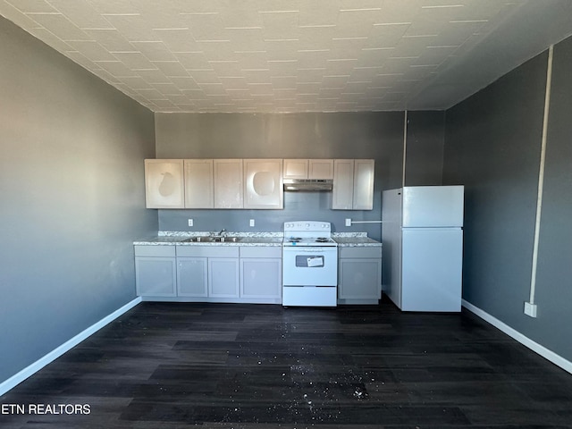 kitchen featuring dark wood-type flooring, light stone countertops, white appliances, and sink