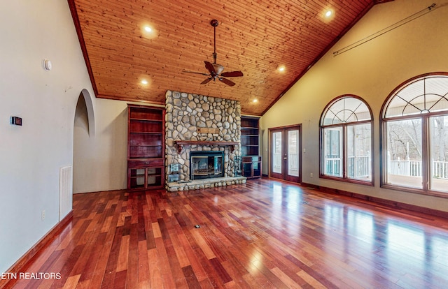 unfurnished living room with high vaulted ceiling, wooden ceiling, built in features, and a fireplace