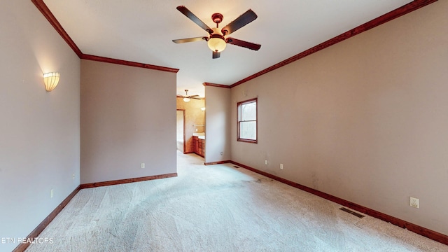 carpeted empty room with ornamental molding and ceiling fan