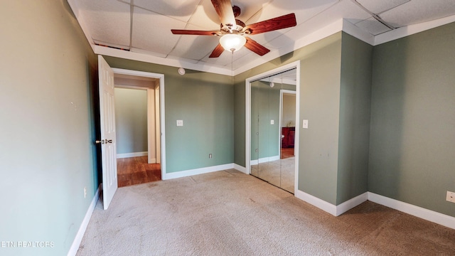 unfurnished bedroom with a closet, carpet, and ceiling fan