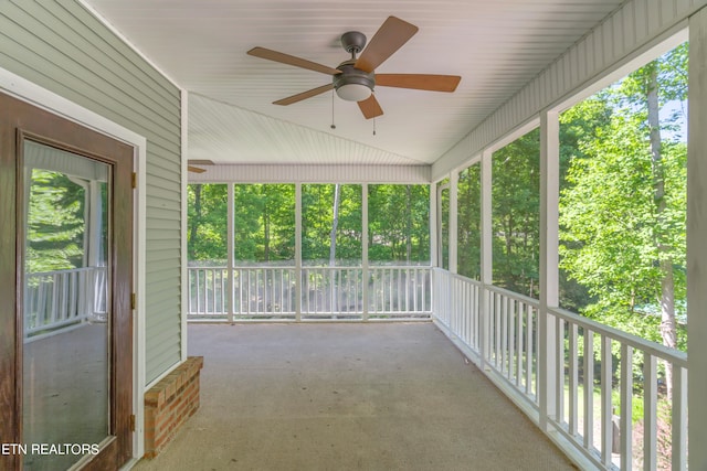 unfurnished sunroom featuring ceiling fan