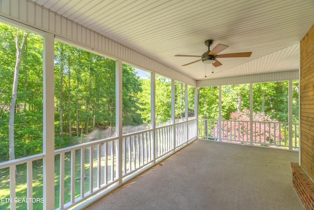 unfurnished sunroom with plenty of natural light and ceiling fan