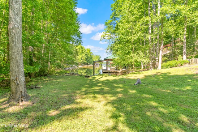 view of yard featuring a wooden deck and a gazebo