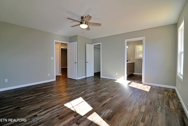 unfurnished bedroom with multiple windows, dark wood-type flooring, and ceiling fan