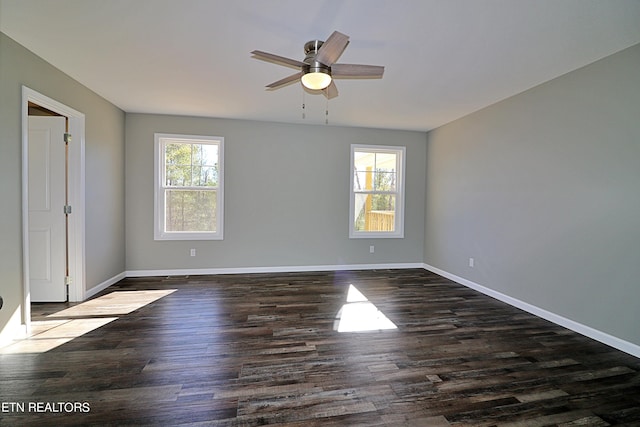 spare room featuring dark hardwood / wood-style flooring and ceiling fan