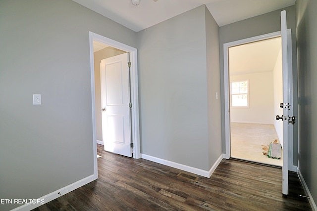 empty room with dark hardwood / wood-style flooring